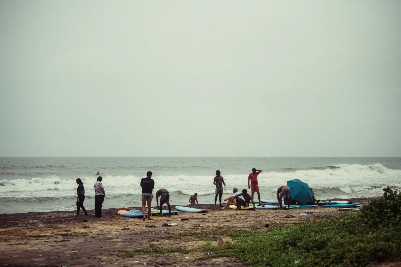 Paddlecult community preparing surfboards on the beach