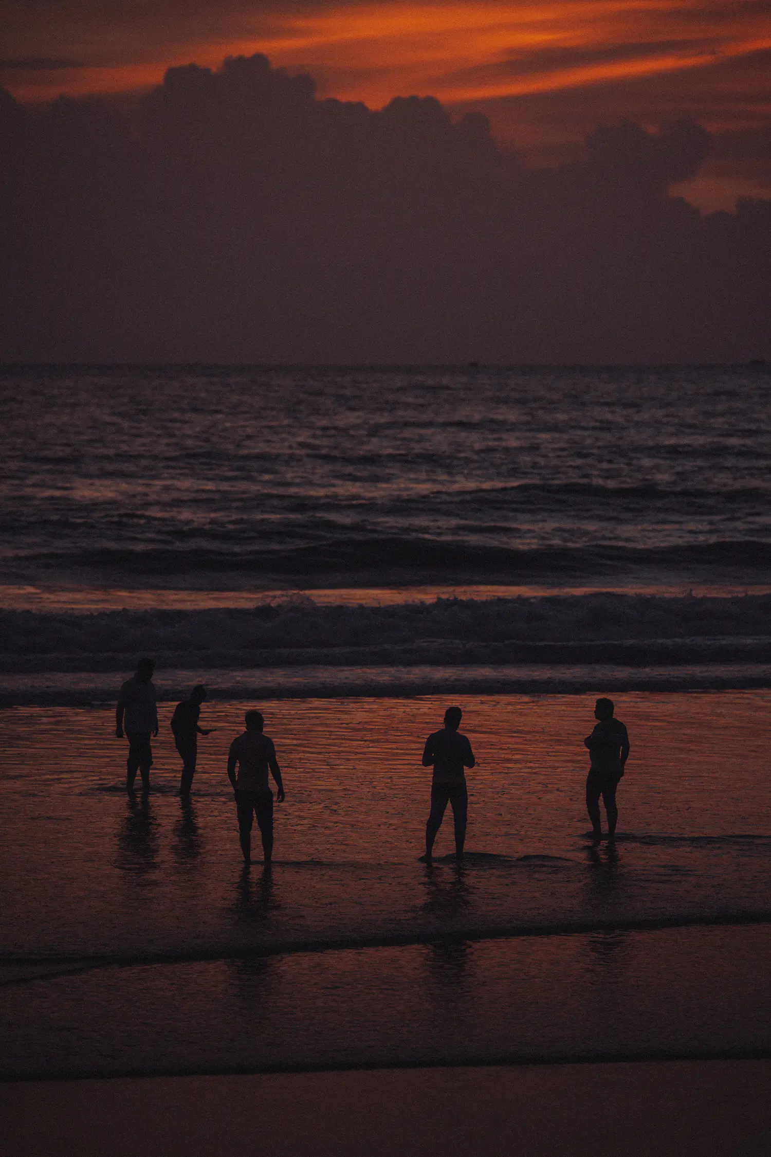 Friends watching the sun set over the Arabian Sea