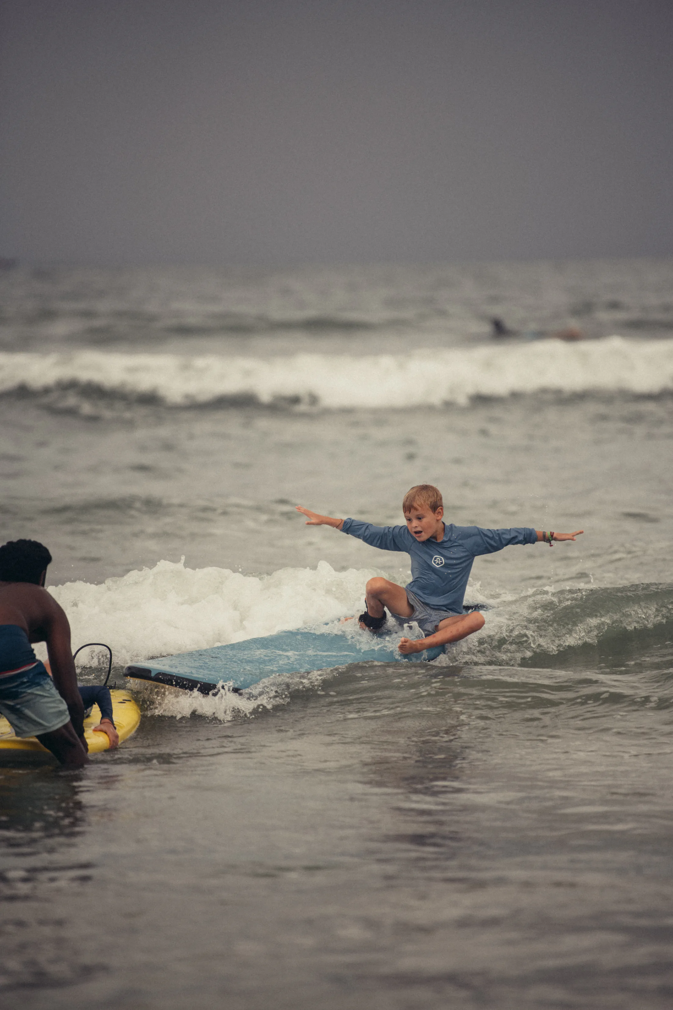 A surfer riding a wave with Paddlecult in Varkala