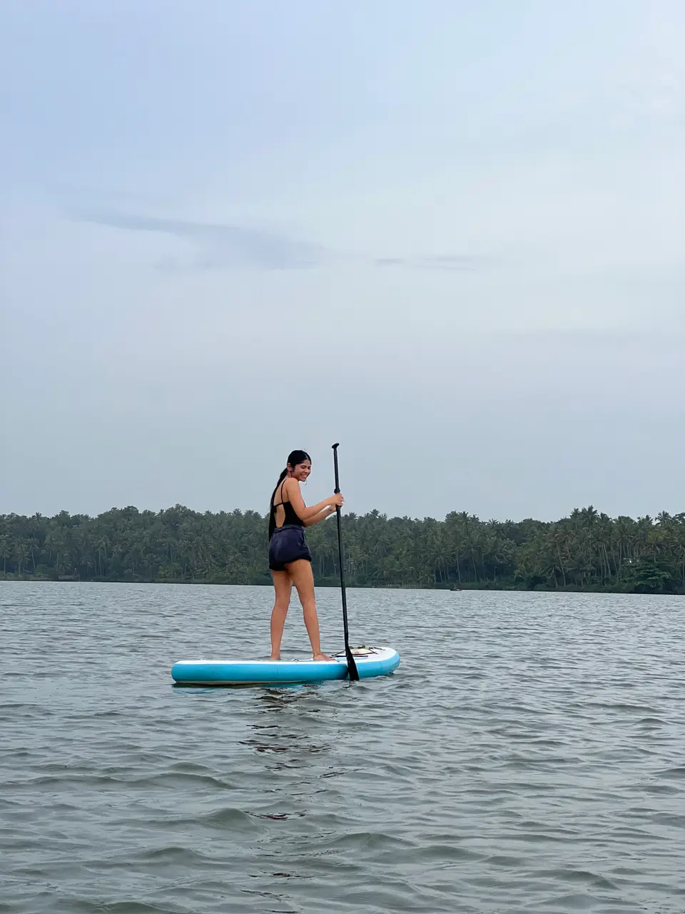 A paddleboarder on calm water