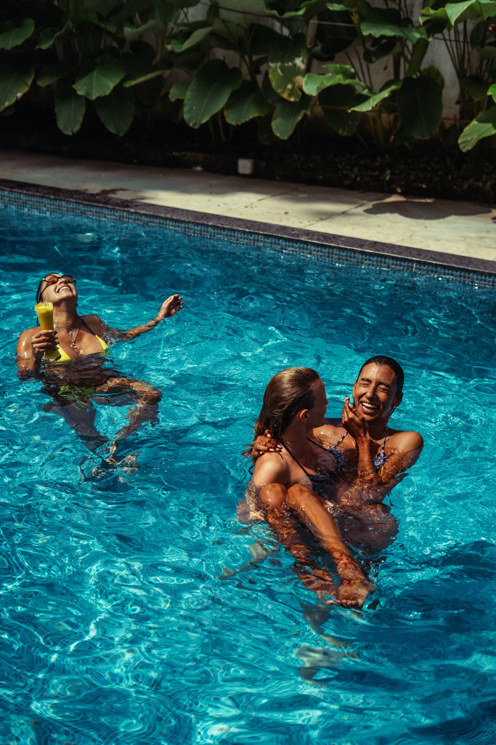 Friends spending time beside the pool at Paddlecult