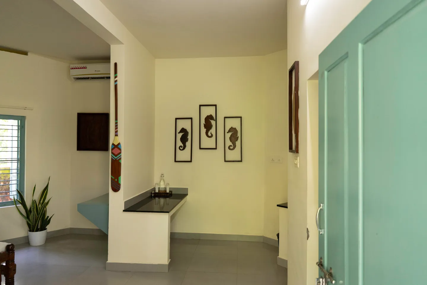 Cottage interior with a washbasin and blue wooden door